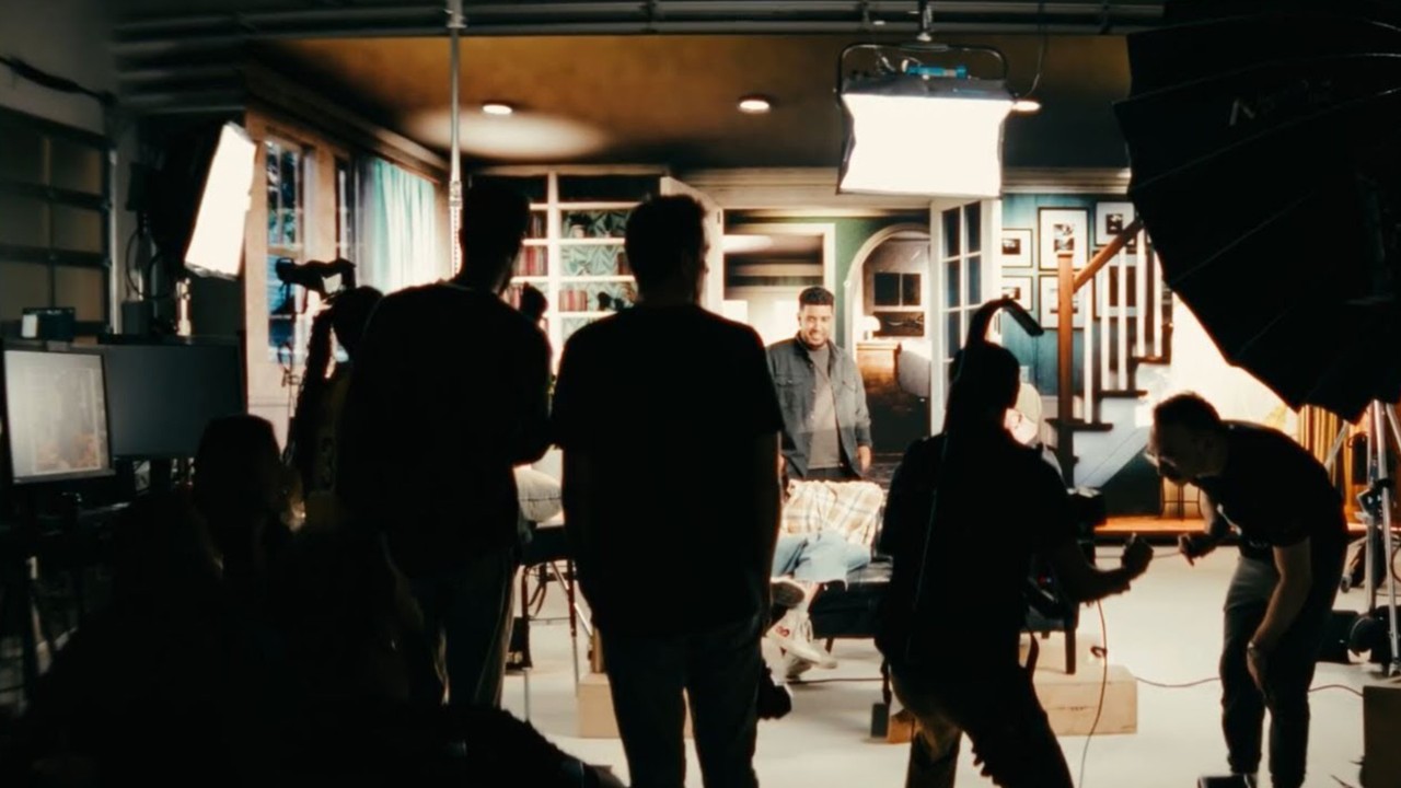 A photo of people in a studio capturing a scene on  camera