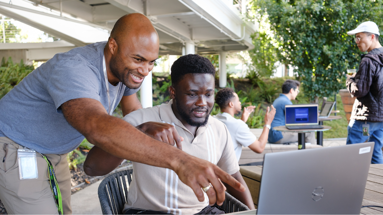 An NVIDIA employee coaching a new trainee in the New College Graduate (NCG) program