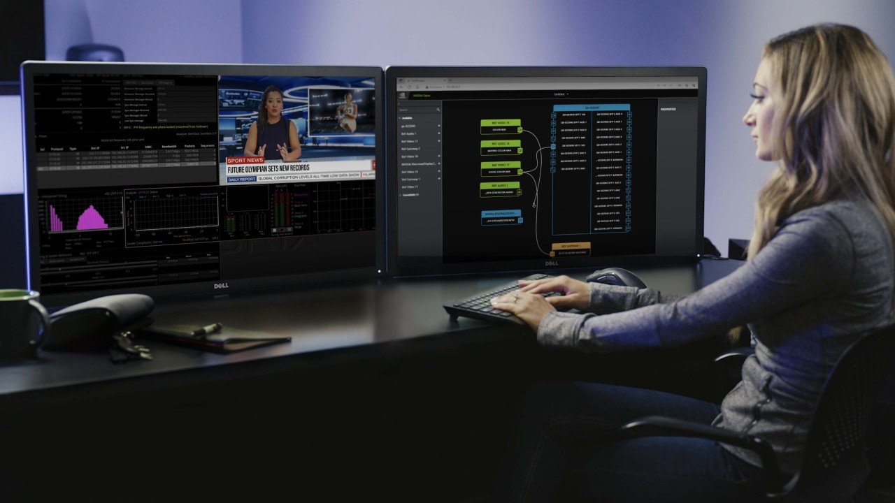 A broadcaster using Holoscan for media on two desktop screens. 