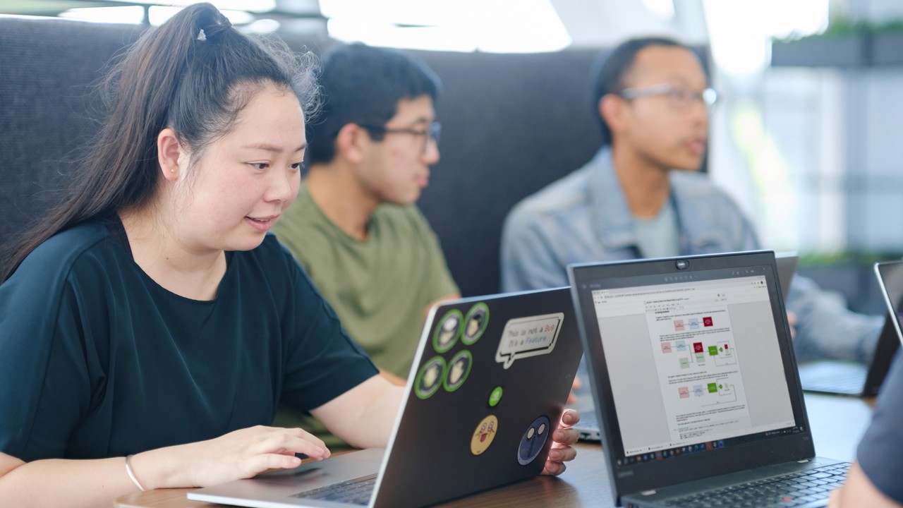 A group of developers explore teaching resources from NVIDIA Deep Learning Institute (DLI)