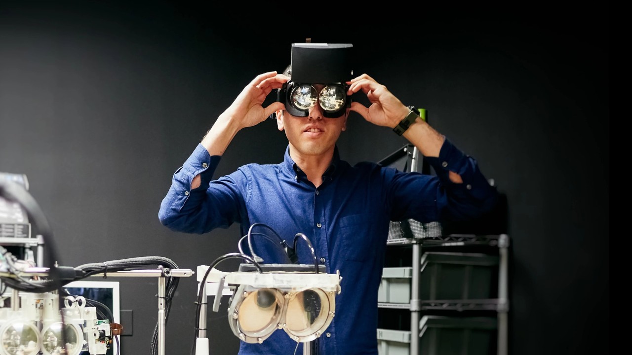 An engineer is testing a VR head set in the lab